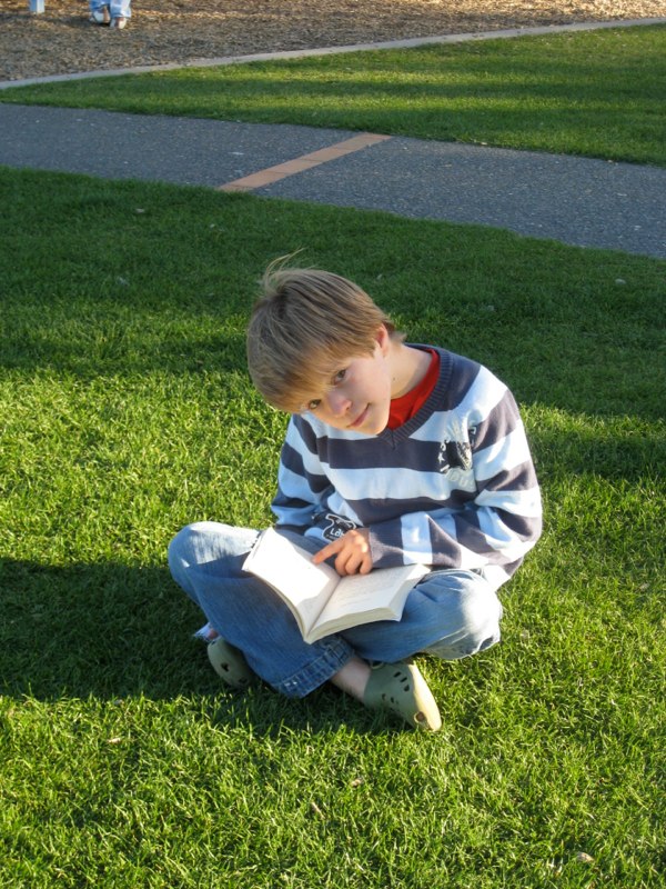 Oskar reading in the park