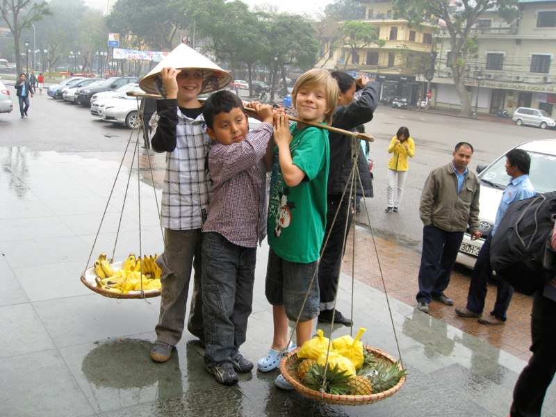 The boy’s tries to carry some fruits